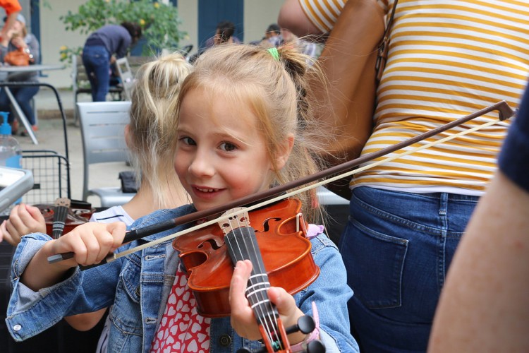 Smiling girl trying out violin